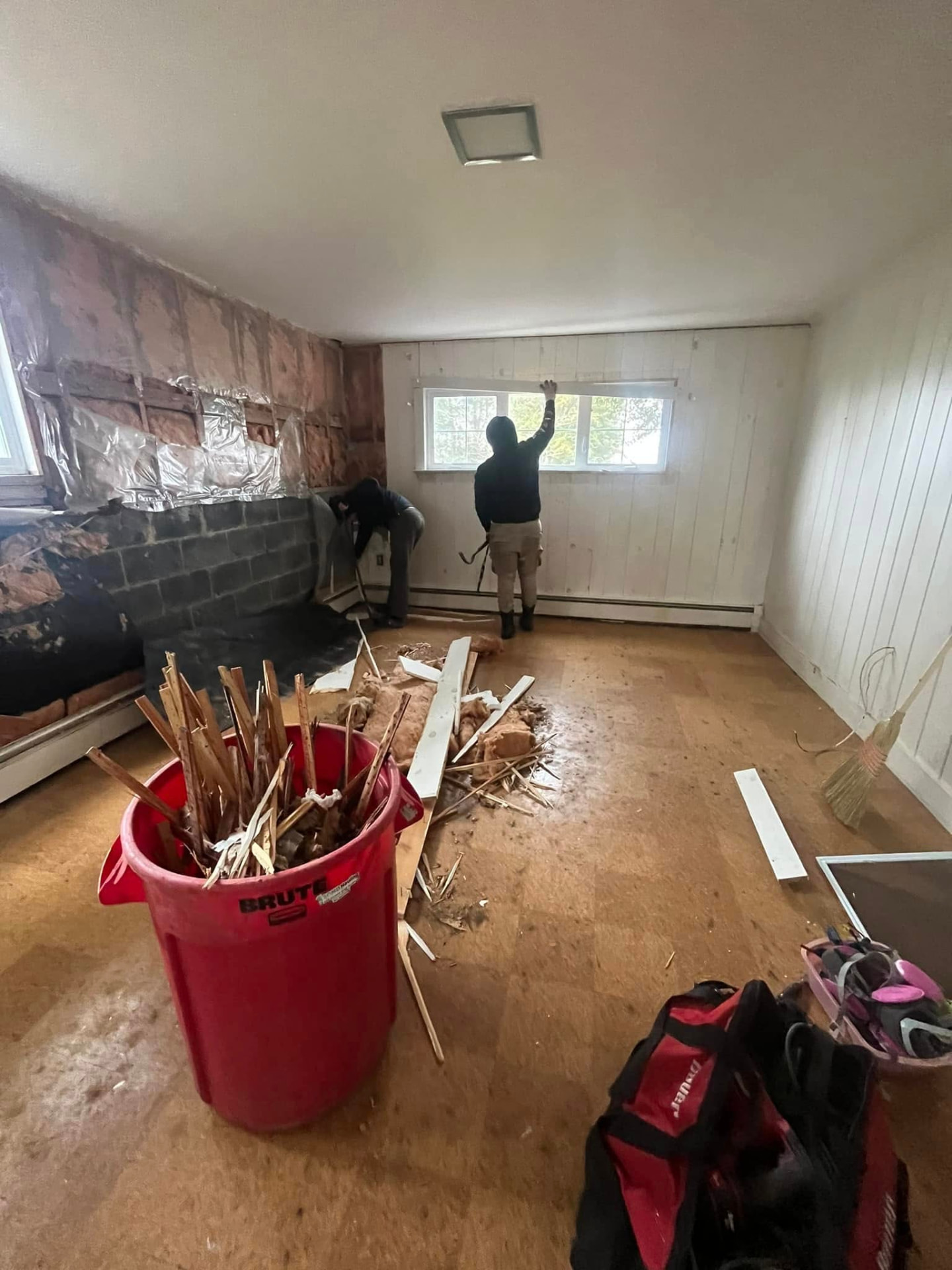 Interior demolition with debris going into a bin